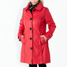 Load image into Gallery viewer, Raincoat by Pipduck in red polyurethane with piped black edging , fully lined with detachable hood.
