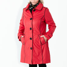 Load image into Gallery viewer, Raincoat by Pipduck in red polyurethane with piped black edging , fully lined with detachable hood.
