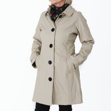 Load image into Gallery viewer, Raincoat by Pipduck in beige polyurethane, fully lined with detachable hood.
